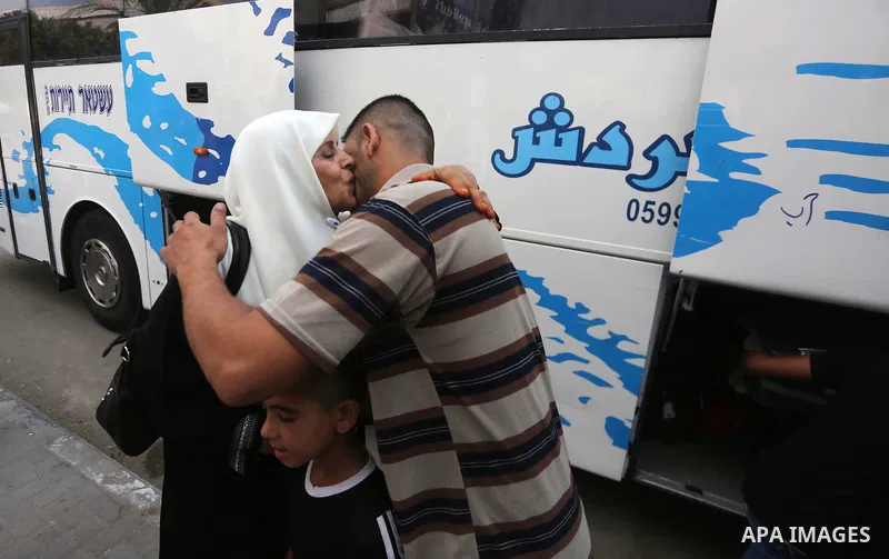 Palestinian Muslim pilgrims wave towards their relatives before leaving for the annual haj pilgrimage to the holy city of Mecca, in Gaza city on August 14, 2017. Photo by Mohammed Asad
