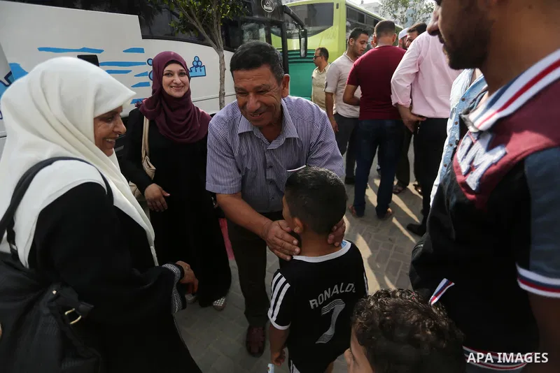 Palestinian Muslim pilgrims wave towards their relatives before leaving for the annual haj pilgrimage to the holy city of Mecca, in Gaza city on August 14, 2017. Photo by Mohammed Asad