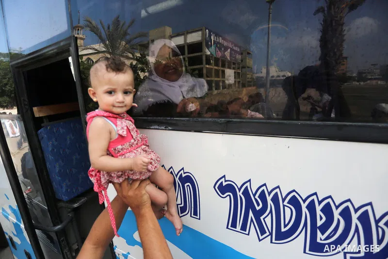 Palestinian Muslim pilgrims wave towards their relatives before leaving for the annual haj pilgrimage to the holy city of Mecca, in Gaza city on August 14, 2017. Photo by Mohammed Asad