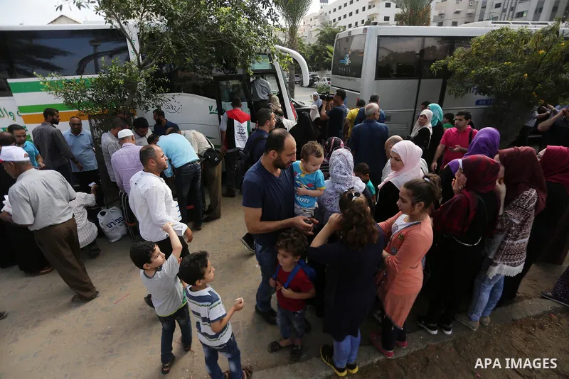 Palestinian Muslim pilgrims wave towards their relatives before leaving for the annual haj pilgrimage to the holy city of Mecca, in Gaza city on August 14, 2017. Photo by Mohammed Asad
