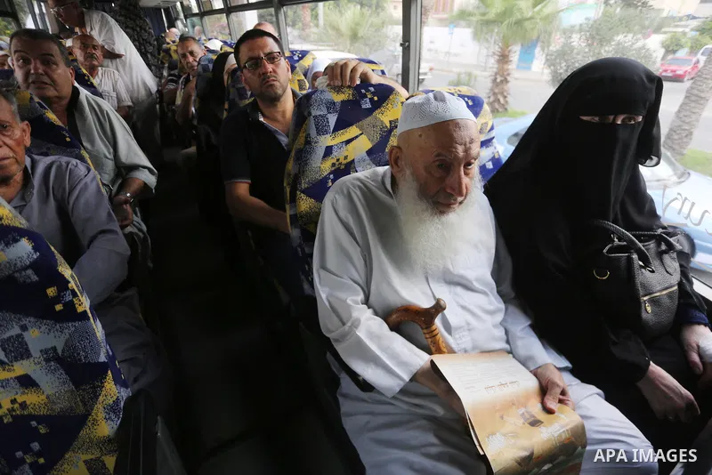 Palestinian Muslim pilgrims wave towards their relatives before leaving for the annual haj pilgrimage to the holy city of Mecca, in Gaza city on August 14, 2017. Photo by Mohammed Asad