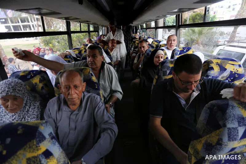 Palestinian Muslim pilgrims wave towards their relatives before leaving for the annual haj pilgrimage to the holy city of Mecca, in Gaza city on August 14, 2017. Photo by Mohammed Asad