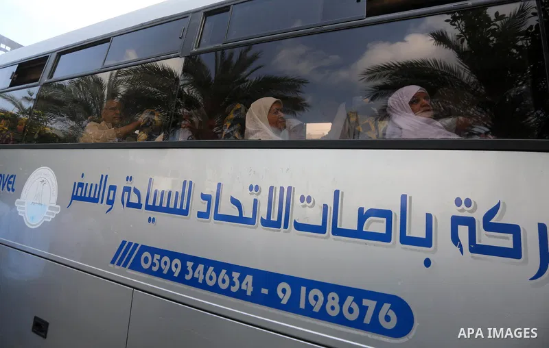 Palestinian Muslim pilgrims wave towards their relatives before leaving for the annual haj pilgrimage to the holy city of Mecca, in Gaza city on August 14, 2017. Photo by Mohammed Asad