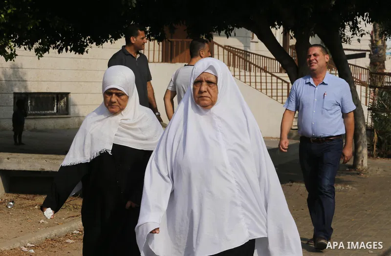 Palestinian Muslim pilgrims wave towards their relatives before leaving for the annual haj pilgrimage to the holy city of Mecca, in Gaza city on August 14, 2017. Photo by Mohammed Asad