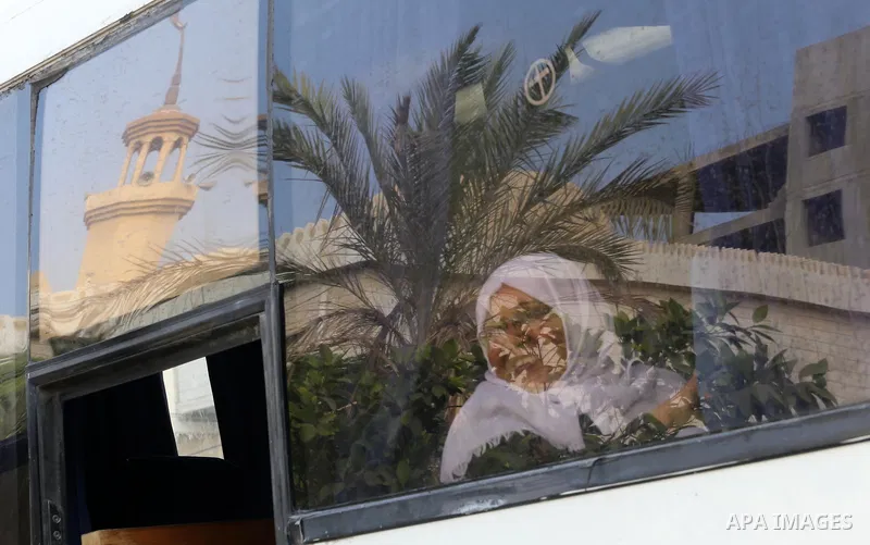 Palestinian Muslim pilgrims wave towards their relatives before leaving for the annual haj pilgrimage to the holy city of Mecca, in Gaza city on August 14, 2017. Photo by Mohammed Asad