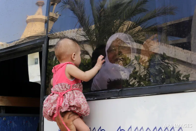 Palestinian Muslim pilgrims wave towards their relatives before leaving for the annual haj pilgrimage to the holy city of Mecca, in Gaza city on August 14, 2017. Photo by Mohammed Asad