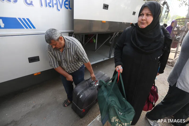 Palestinian Muslim pilgrims wave towards their relatives before leaving for the annual haj pilgrimage to the holy city of Mecca, in Gaza city on August 14, 2017. Photo by Mohammed Asad