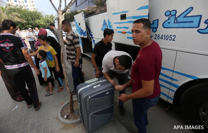 Palestinian Muslim pilgrims wave towards their relatives before leaving for the annual haj pilgrimage to the holy city of Mecca, in Gaza city on August 14, 2017. Photo by Mohammed Asad