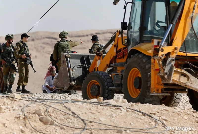 Israeli troops and bulldozers are seen as they demolish a house in the Palestinian bedouin village of Khashm al-Daraj in the southern area of Yatta, south of the West Bank city of Hebron, on August 14, 2017. Photo by Wis...