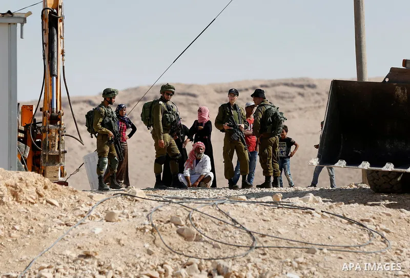 Israeli troops and bulldozers are seen as they demolish a house in the Palestinian bedouin village of Khashm al-Daraj in the southern area of Yatta, south of the West Bank city of Hebron, on August 14, 2017. Photo by Wis...