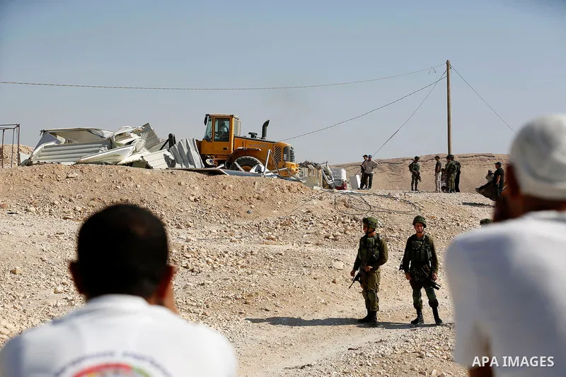 Israeli troops and bulldozers are seen as they demolish a house in the Palestinian bedouin village of Khashm al-Daraj in the southern area of Yatta, south of the West Bank city of Hebron, on August 14, 2017. Photo by Wis...