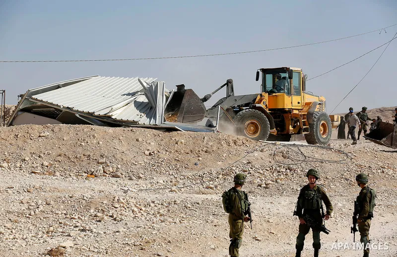 Israeli troops and bulldozers are seen as they demolish a house in the Palestinian bedouin village of Khashm al-Daraj in the southern area of Yatta, south of the West Bank city of Hebron, on August 14, 2017. Photo by Wis...