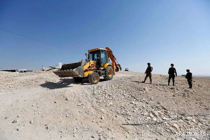 Israeli troops and bulldozers are seen as they demolish a house in the Palestinian bedouin village of Khashm al-Daraj in the southern area of Yatta, south of the West Bank city of Hebron, on August 14, 2017. Photo by Wis...