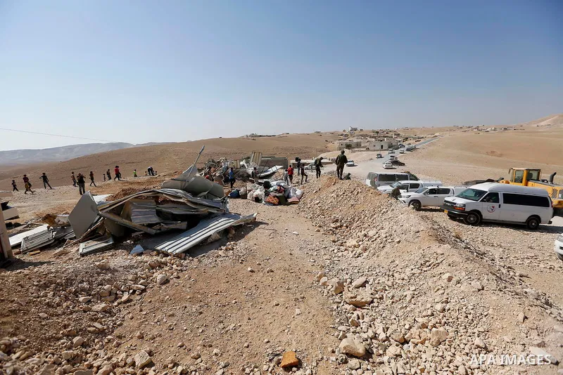 Israeli troops and bulldozers are seen as they demolish a house in the Palestinian bedouin village of Khashm al-Daraj in the southern area of Yatta, south of the West Bank city of Hebron, on August 14, 2017. Photo by Wis...