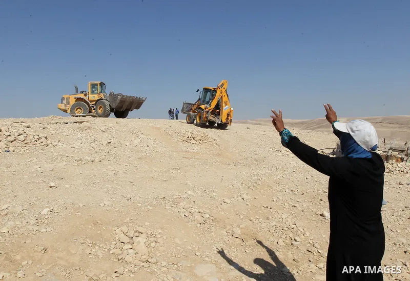 A Palestinian woman cries as Israeli troops demolish houses in the bedouin village of Khashm al-Daraj in the southern area of Yatta, south of the West Bank city of Hebron, on August 14, 2017. Photo by Wisam Hashlamoun