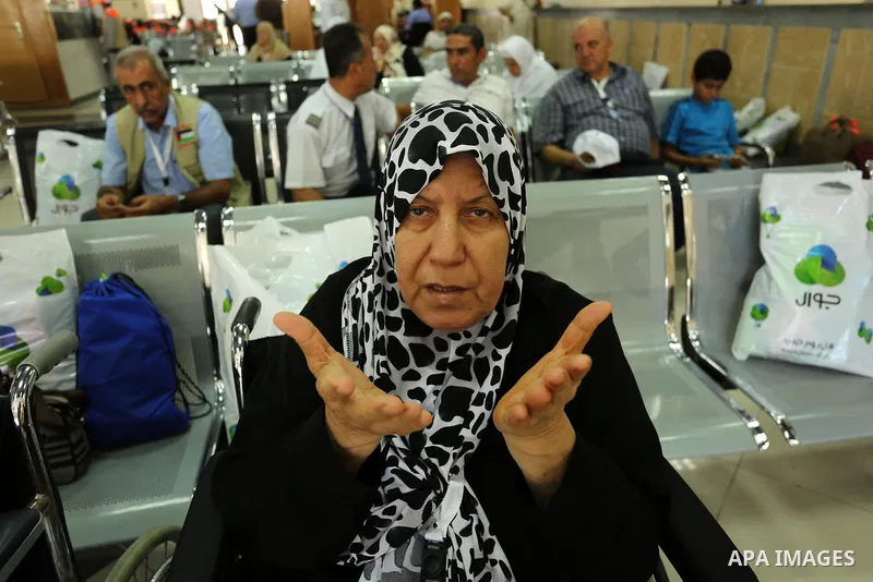 Palestinian Muslim pilgrims wave towards their relatives before leaving for the annual haj pilgrimage to the holy city of Mecca, in Khan Younis in the southern Gaza Strip on August 14, 2017. Photo by Ashraf Amra