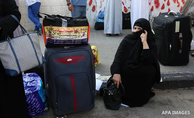 Palestinian Muslim pilgrims wave towards their relatives before leaving for the annual haj pilgrimage to the holy city of Mecca, in Khan Younis in the southern Gaza Strip on August 14, 2017. Photo by Ashraf Amra