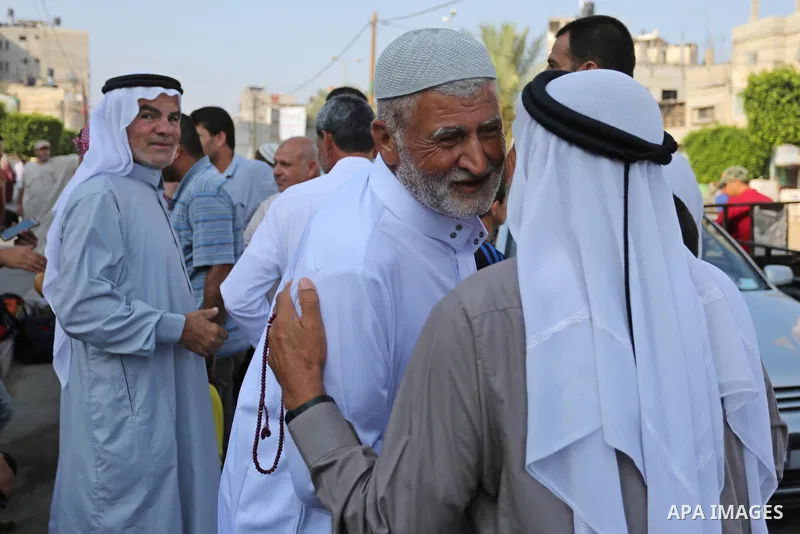 Palestinian Muslim pilgrims wave towards their relatives before leaving for the annual haj pilgrimage to the holy city of Mecca, in Khan Younis in the southern Gaza Strip on August 14, 2017. Photo by Ashraf Amra