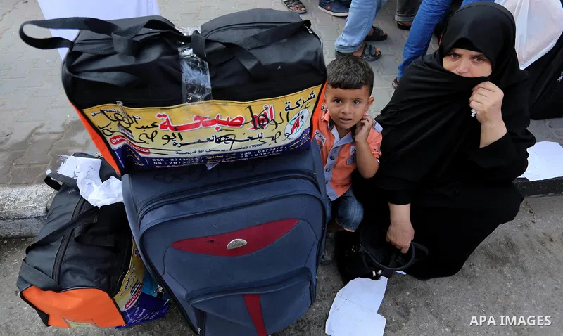 Palestinian Muslim pilgrims wave towards their relatives before leaving for the annual haj pilgrimage to the holy city of Mecca, in Khan Younis in the southern Gaza Strip on August 14, 2017. Photo by Ashraf Amra