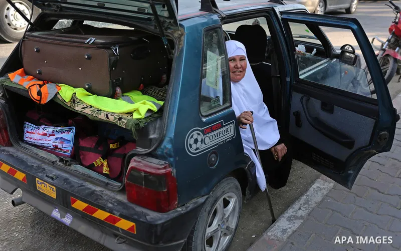 Palestinian Muslim pilgrims wave towards their relatives before leaving for the annual haj pilgrimage to the holy city of Mecca, in Khan Younis in the southern Gaza Strip on August 14, 2017. Photo by Ashraf Amra