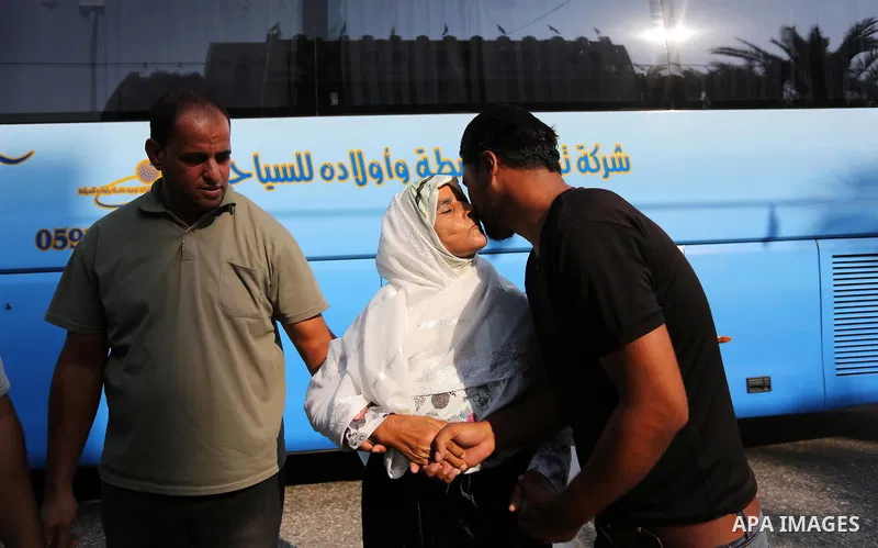 Palestinian Muslim pilgrims wave towards their relatives before leaving for the annual haj pilgrimage to the holy city of Mecca, in Khan Younis in the southern Gaza Strip on August 14, 2017. Photo by Ashraf Amra