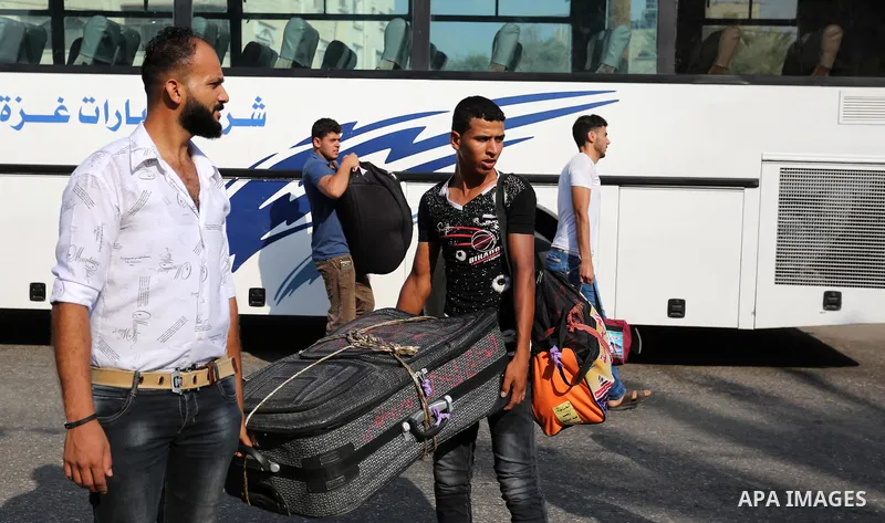 Palestinian Muslim pilgrims wave towards their relatives before leaving for the annual haj pilgrimage to the holy city of Mecca, in Khan Younis in the southern Gaza Strip on August 14, 2017. Photo by Ashraf Amra