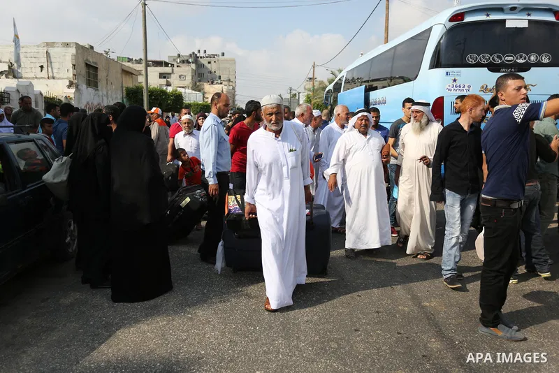 Palestinian Muslim pilgrims wave towards their relatives before leaving for the annual haj pilgrimage to the holy city of Mecca, in Khan Younis in the southern Gaza Strip on August 14, 2017. Photo by Ashraf Amra