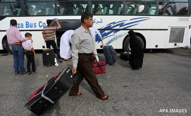 Palestinian Muslim pilgrims wave towards their relatives before leaving for the annual haj pilgrimage to the holy city of Mecca, in Khan Younis in the southern Gaza Strip on August 14, 2017. Photo by Ashraf Amra