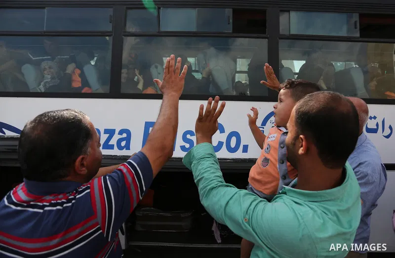 Palestinian Muslim pilgrims wave towards their relatives before leaving for the annual haj pilgrimage to the holy city of Mecca, in Khan Younis in the southern Gaza Strip on August 14, 2017. Photo by Ashraf Amra
