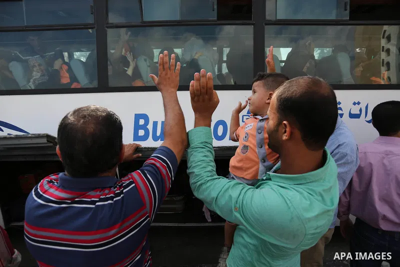 Palestinian Muslim pilgrims wave towards their relatives before leaving for the annual haj pilgrimage to the holy city of Mecca, in Khan Younis in the southern Gaza Strip on August 14, 2017. Photo by Ashraf Amra