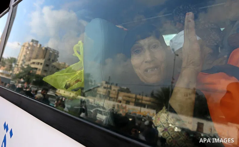 Palestinian Muslim pilgrims wave towards their relatives before leaving for the annual haj pilgrimage to the holy city of Mecca, in Khan Younis in the southern Gaza Strip on August 14, 2017. Photo by Ashraf Amra