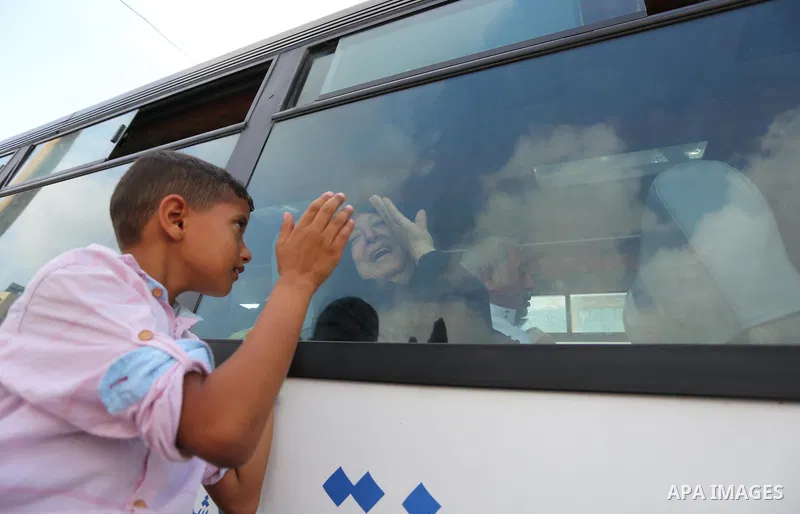 Palestinian Muslim pilgrims wave towards their relatives before leaving for the annual haj pilgrimage to the holy city of Mecca, in Khan Younis in the southern Gaza Strip on August 14, 2017. Photo by Ashraf Amra