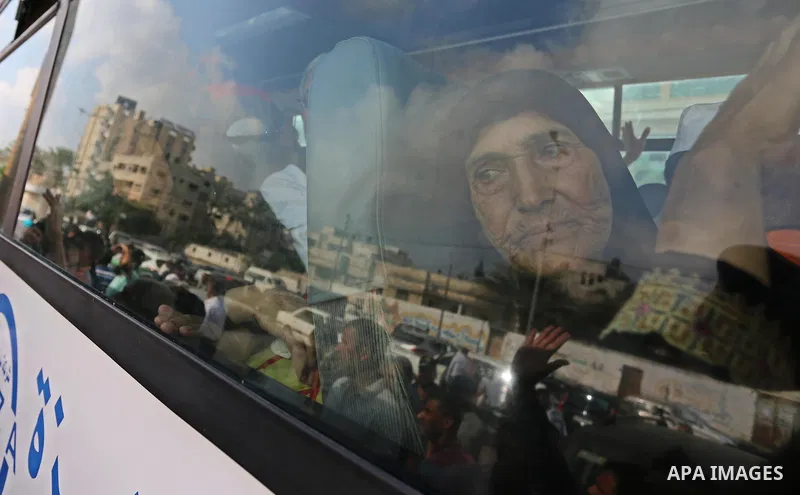 Palestinian Muslim pilgrims wave towards their relatives before leaving for the annual haj pilgrimage to the holy city of Mecca, in Khan Younis in the southern Gaza Strip on August 14, 2017. Photo by Ashraf Amra