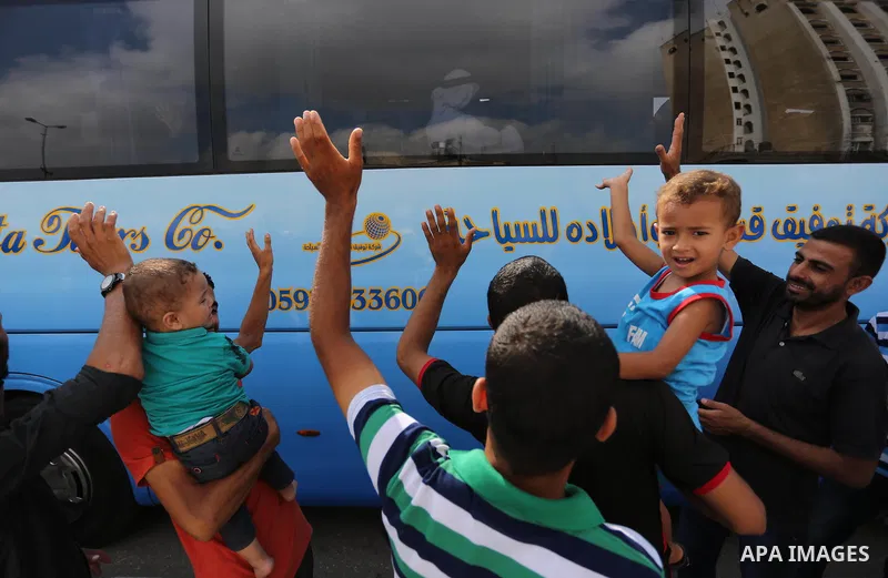 Palestinian Muslim pilgrims wave towards their relatives before leaving for the annual haj pilgrimage to the holy city of Mecca, in Khan Younis in the southern Gaza Strip on August 14, 2017. Photo by Ashraf Amra