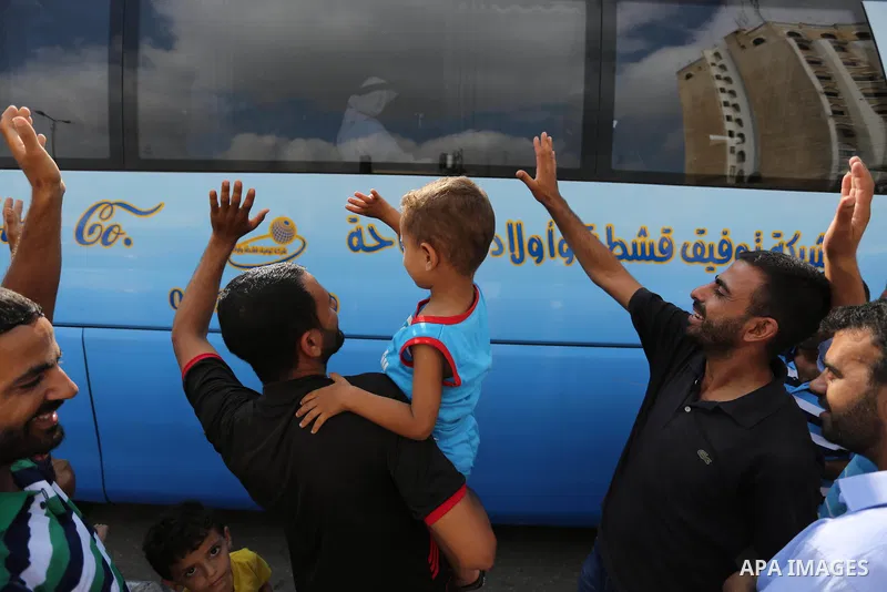 Palestinian Muslim pilgrims wave towards their relatives before leaving for the annual haj pilgrimage to the holy city of Mecca, in Khan Younis in the southern Gaza Strip on August 14, 2017. Photo by Ashraf Amra