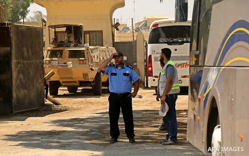 Egyptian security forces stand guard at the border as Palestinian Muslim pilgrims arrive at the Rafah crossing between Egypt and the southern Gaza Strip, on August 14, 2017, ahead of their departure to the annual Hajj pi...