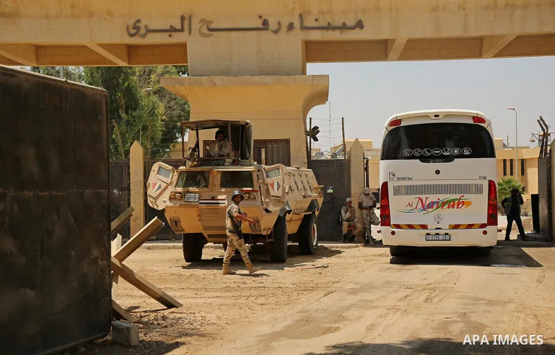 Egyptian security forces stand guard at the border as Palestinian Muslim pilgrims arrive at the Rafah crossing between Egypt and the southern Gaza Strip, on August 14, 2017, ahead of their departure to the annual Hajj pi...