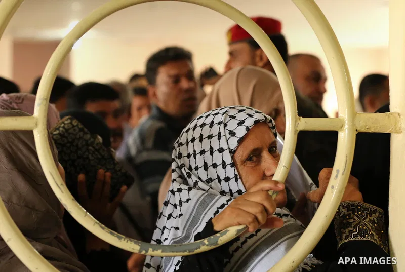 Palestinians wait for travel permits to cross into Egypt through the Rafah border crossing after it was opened by Egyptian authorities for humanitarian cases, in Rafah in the southern Gaza Strip on August 16, 2017. Photo...