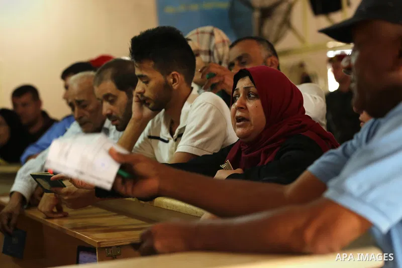 Palestinians wait for travel permits to cross into Egypt through the Rafah border crossing after it was opened by Egyptian authorities for humanitarian cases, in Rafah in the southern Gaza Strip on August 16, 2017. Photo...