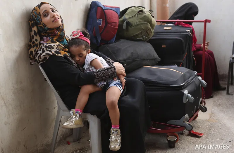 Palestinians wait for travel permits to cross into Egypt through the Rafah border crossing after it was opened by Egyptian authorities for humanitarian cases, in Rafah in the southern Gaza Strip on August 16, 2017. Photo...