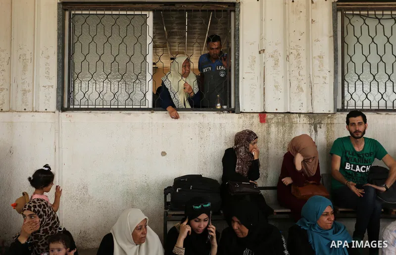 Palestinians wait for travel permits to cross into Egypt through the Rafah border crossing after it was opened by Egyptian authorities for humanitarian cases, in Rafah in the southern Gaza Strip on August 16, 2017. Photo...