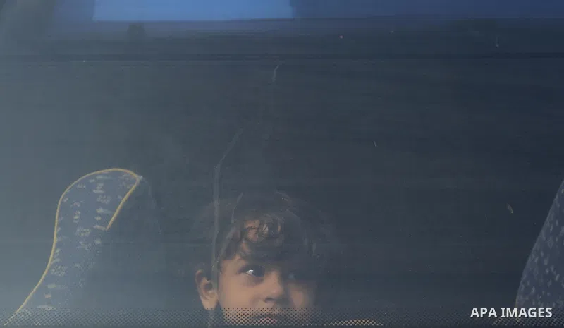 Palestinians wait for travel permits to cross into Egypt through the Rafah border crossing after it was opened by Egyptian authorities for humanitarian cases, in Rafah in the southern Gaza Strip on August 16, 2017. Photo...