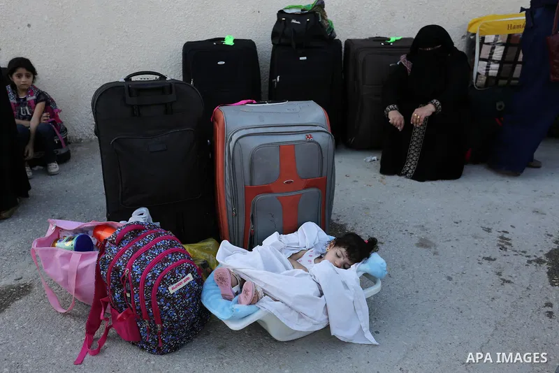 Palestinians wait for travel permits to cross into Egypt through the Rafah border crossing after it was opened by Egyptian authorities for humanitarian cases, in Rafah in the southern Gaza Strip on August 16, 2017. Photo...