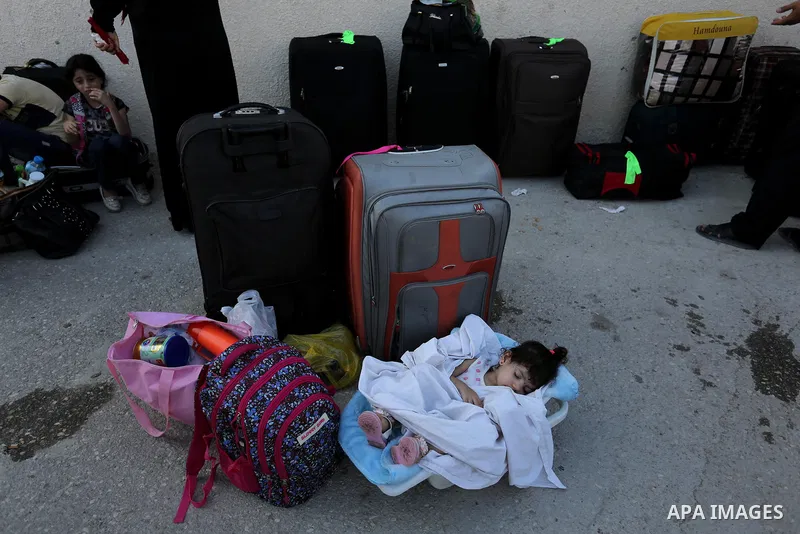 Palestinians wait for travel permits to cross into Egypt through the Rafah border crossing after it was opened by Egyptian authorities for humanitarian cases, in Rafah in the southern Gaza Strip on August 16, 2017. Photo...