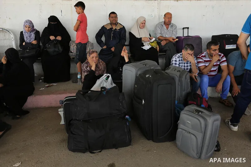 Palestinians wait for travel permits to cross into Egypt through the Rafah border crossing after it was opened by Egyptian authorities for humanitarian cases, in Rafah in the southern Gaza Strip on August 16, 2017. Photo...
