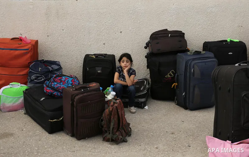 Palestinians wait for travel permits to cross into Egypt through the Rafah border crossing after it was opened by Egyptian authorities for humanitarian cases, in Rafah in the southern Gaza Strip on August 16, 2017. Photo...
