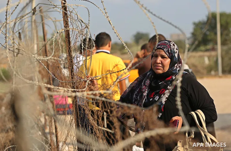 Palestinians wait for travel permits to cross into Egypt through the Rafah border crossing after it was opened by Egyptian authorities for humanitarian cases, in Rafah in the southern Gaza Strip on August 16, 2017. Photo...
