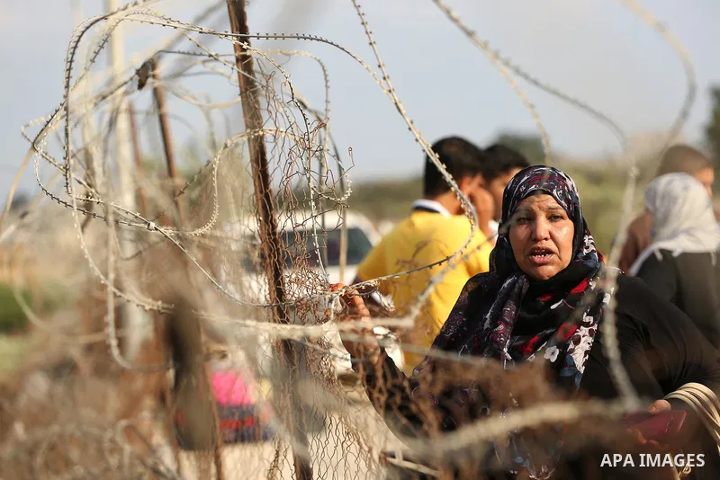 Palestinians wait for travel permits to cross into Egypt through the Rafah border crossing after it was opened by Egyptian authorities for humanitarian cases, in Rafah in the southern Gaza Strip on August 16, 2017. Photo...