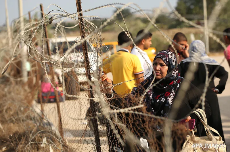 Palestinians wait for travel permits to cross into Egypt through the Rafah border crossing after it was opened by Egyptian authorities for humanitarian cases, in Rafah in the southern Gaza Strip on August 16, 2017. Photo...