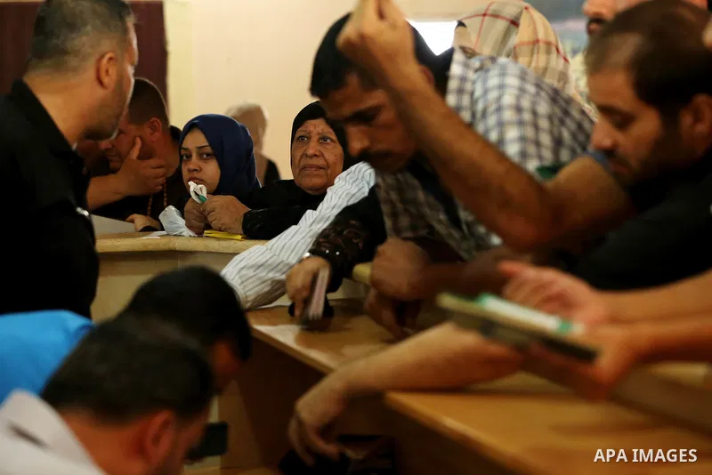 Palestinians wait for travel permits to cross into Egypt through the Rafah border crossing after it was opened by Egyptian authorities for humanitarian cases, in Rafah in the southern Gaza Strip on August 16, 2017. Photo...